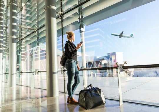 Woman with luggage standing at the airport