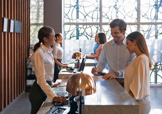A couple checking in at a hotel